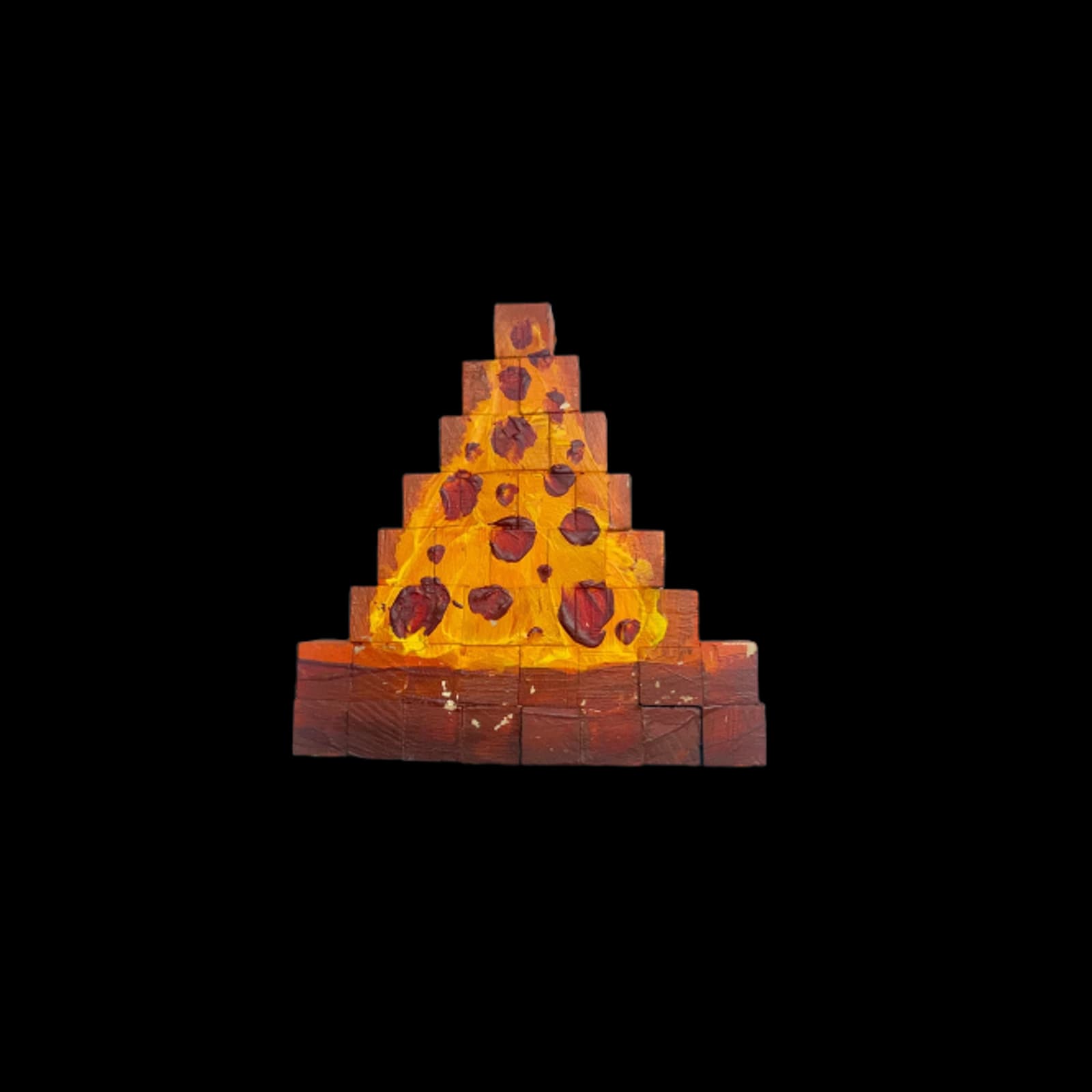 Small tiered handmade sculpture with orange, yellow, and brown painted accents on a black background.